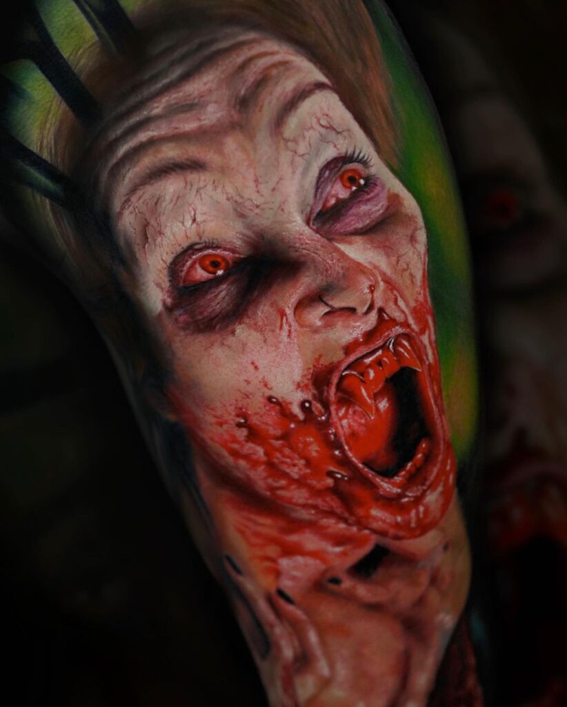 Halloween tattoos: Colour realism tattoo showing female vampire covered in blood.