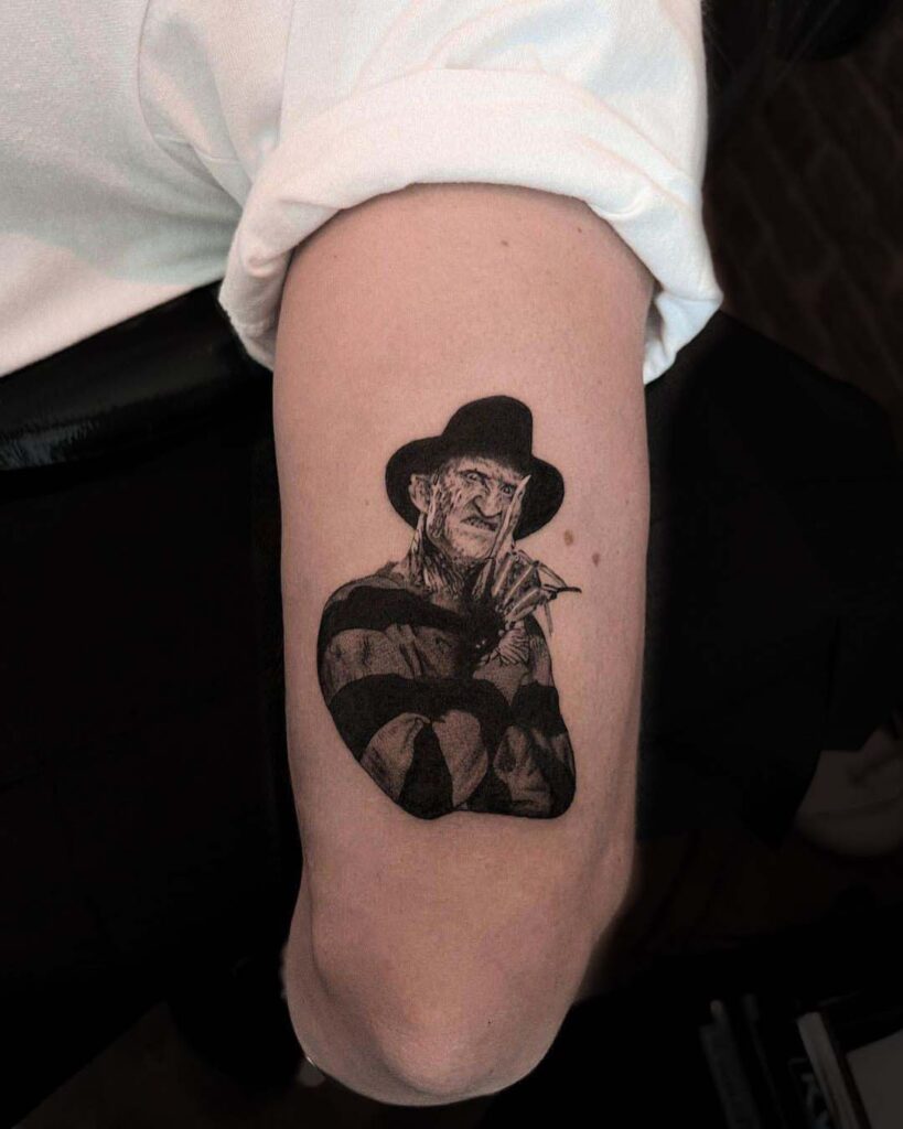 Black and grey Freddy Krueger tattoo.