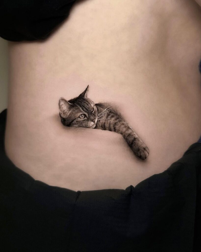 micro realism tattoo of cat lying down. Tattoo done by Bugra Bizel, one of our resident artists at No Regrets Cardiff.